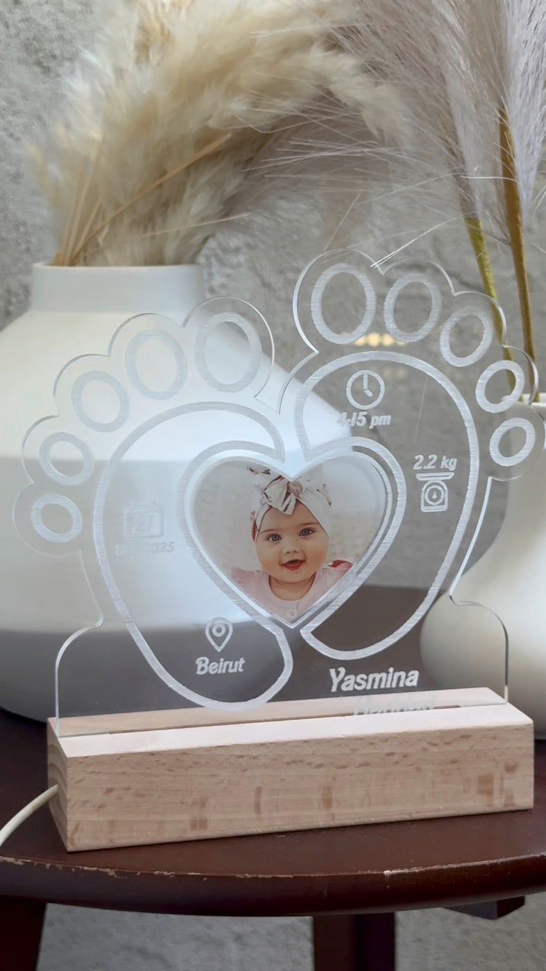 Baby footprints plaque styled on a side table
