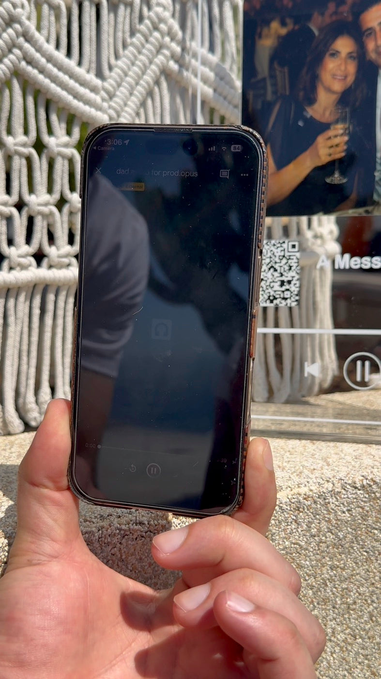 Scanning the QR code on the music plaque with a phone