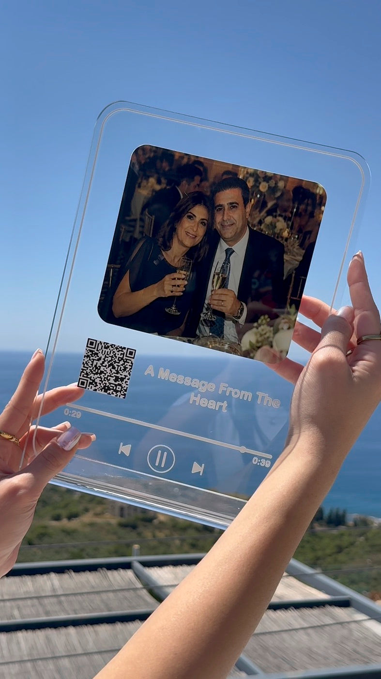 Acrylic music plaque held against the sky